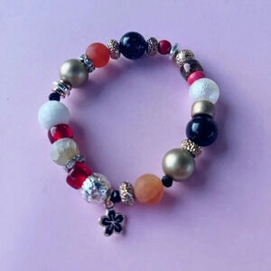 Handmade beaded statement bracelet with flower charm